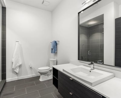 Modern guest bathroom featuring a glass walk-in shower, updated fixtures, and clean contemporary finishes in this Phoenix property.