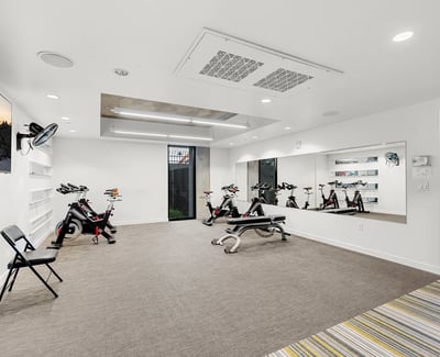 Dedicated studio for yoga and cycling, featuring mirrored walls and flexible space for wellness activities in Phoenix.