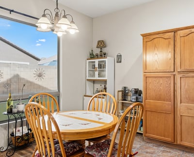 Cozy dining space with large window and backyard views, offering a bright and welcoming setting for meals in this Phoenix home.