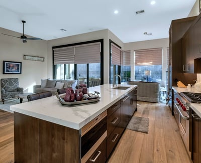 Open kitchen with oversized island, quartz surfaces, and seamless flow into the living area perfect for entertaining in this Phoenix home.