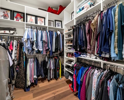 Custom closet with extensive shelving and hanging space, offering efficient organization in this Phoenix luxury residence.