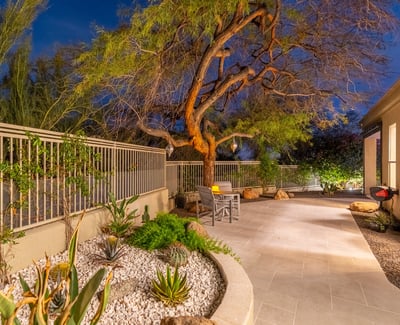 Low-maintenance Scottsdale landscaping with native plants, decorative rock, and a spacious patio walkway designed for beauty and efficiency.