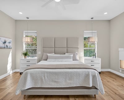 Stylish Scottsdale bedroom with abundant natural light, updated lighting fixtures, and neutral finishes for a calm, contemporary feel.