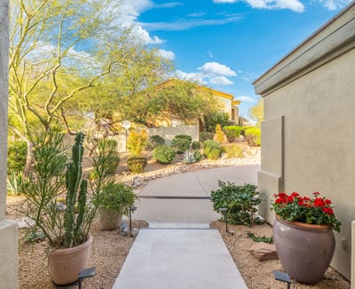 Scottsdale entry path with desert plants, stone accents, and low-maintenance landscaping leading to the front entrance.