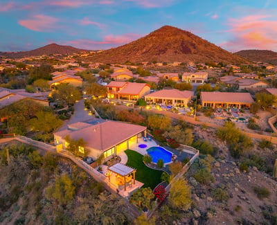 Scottsdale aerial showcasing the elevated homesite, resort-style backyard, and panoramic desert and mountain views.