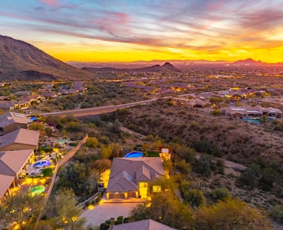 Scottsdale aerial highlighting nearby mountains, desert landscape, and surrounding homes in a scenic environment.