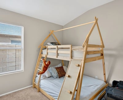 Cozy bedroom with neutral tones and natural light. Perfect for relaxation or guest use in this Casa Grande home.