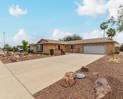 Side angle highlighting the home s structure, landscaping, and spacious lot. Located in Sun City, this property offers low-maintenance outdoor living.