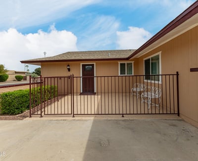 Secure front patio with gated entry, ideal for outdoor seating. This Sun City home features updated finishes and inviting outdoor spaces.