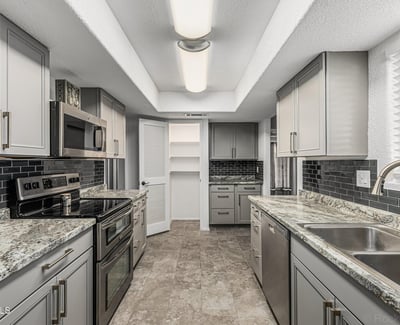 Efficient galley kitchen with ample cabinetry, modern lighting, and upgraded finishes. This Sun City home offers a practical layout for daily living.