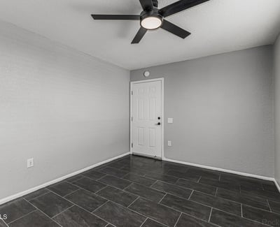 Flexible interior space with tile flooring and ceiling fan. This Sun City home provides options for office, guest room, or hobby area.