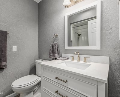 Updated bathroom with contemporary vanity, fixtures, and lighting. This Sun City home showcases refreshed interiors and stylish upgrades.