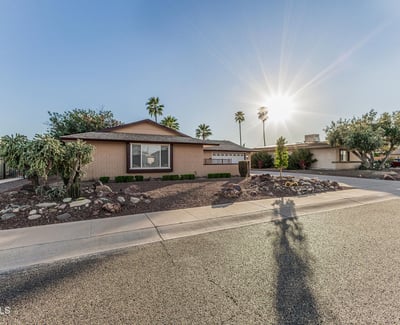 Beautiful front yard with desert landscaping, mature greenery, and attractive curb appeal. This Sun City home offers easy-care outdoor spaces and a welcoming exterior.