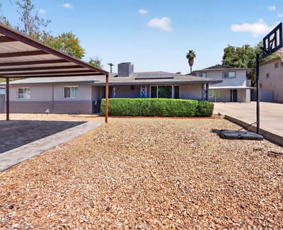 Durable paver parking under a covered structure provides style and practicality for this upgraded Phoenix multi-unit property.