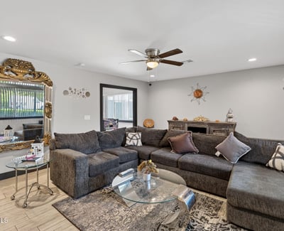 Inviting living room with updated flooring and abundant natural light, enhancing the overall appeal of this Phoenix remodeled home.