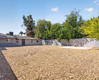 Generous backyard with gravel landscaping and open space, perfect for outdoor enjoyment and easy upkeep in this Phoenix property.