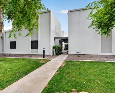 Attractive Scottsdale exterior with green lawn, mature trees, and clean design offering great curb appeal and community atmosphere.