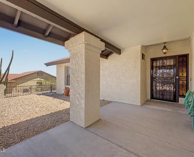 A shaded front porch and decorative gated entry create a warm and inviting arrival experience. This attractive outdoor space adds character while enhancing the home's curb appeal and functionality.