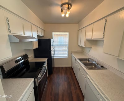 Functional galley-style kitchen featuring extensive cabinetry, generous counter space, and modern appliances. Designed for convenience, this space supports both everyday cooking and efficient organization.