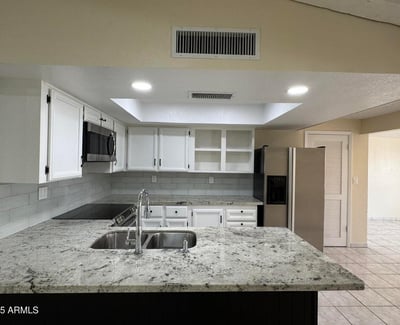 Beautifully updated kitchen with granite counters, recessed lighting, and seamless access to the main living area. Perfect for hosting family and friends.