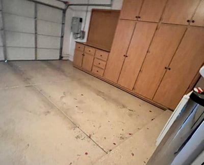 Two-car garage with extensive custom storage cabinets, built-in work area, and generous space for vehicles, tools, and recreational equipment, making organization simple and efficient.