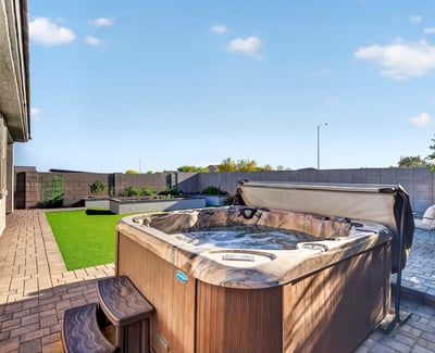 Relax in your own backyard spa surrounded by attractive pavers, lush artificial turf, raised planter beds, and thoughtfully designed outdoor gathering spaces.