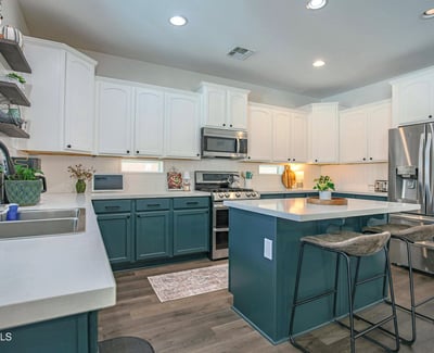 Bright, open kitchen with quartz countertops, stainless steel appliances, generous cabinet storage, and an oversized island perfect for meal prep, entertaining, and everyday living.