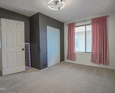 Bright secondary bedroom with soft carpeting, a large window, and convenient closet storage. This versatile room is perfect for a nursery, guest bedroom, playroom, or home office.