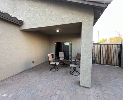 Covered patio creates the perfect shaded outdoor retreat for dining, entertaining, or enjoying quiet evenings while overlooking the spacious backyard.