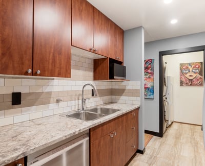Discover this modern kitchen with upgraded appliances and unique artwork, perfect for culinary enthusiasts.
