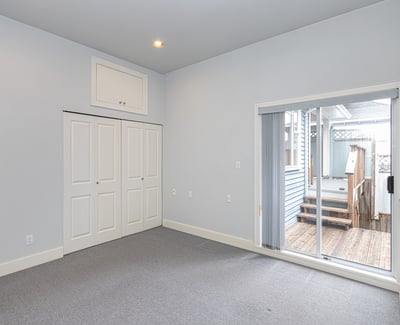 Bright, versatile room with large closet and direct access to a private outdoor space.
