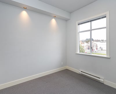 Bright, versatile room with natural light, perfect for a home office or creative space.