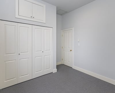 Bright, spacious room featuring built-in storage and a versatile layout, perfect for various living arrangements.