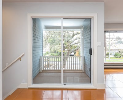 Bright and inviting space with sliding glass doors leading to a cozy patio and garden view.