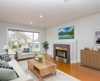 Bright and spacious living room featuring a modern fireplace and large windows for natural light.