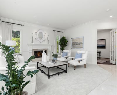 living space features a cozy fireplace and large windows, perfect for relaxation and gatherings.