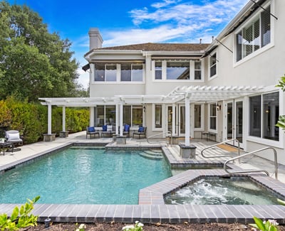 This inviting backyard features a spacious pool and spa, perfect for entertaining and relaxation.