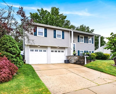 Charming bi-level home with lush greenery.