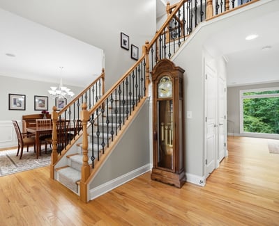Discover a spacious entryway leading to a bright dining area, complemented by stunning wood details.