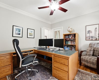 Spacious home office featuring dual workstations, ample storage, and natural light for productive days.