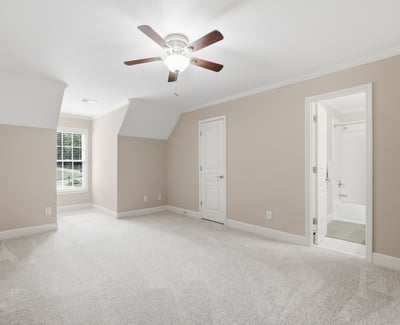 Spacious, multi-functional room featuring plush carpet, natural light, and an en-suite bathroom for convenience.