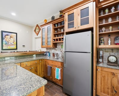 This well-appointed kitchen features ample storage, modern appliances, and a lovely granite countertop perfect for entertaining.