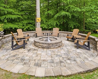 Inviting fire pit area surrounded by nature, perfect for gatherings and cozy evenings outdoors.
