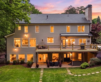 Spacious home with large windows and a welcoming deck, perfect for entertaining and enjoying outdoor views.
