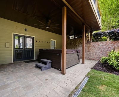 Discover this covered patio featuring a hot tub, perfect for outdoor relaxation and entertaining.