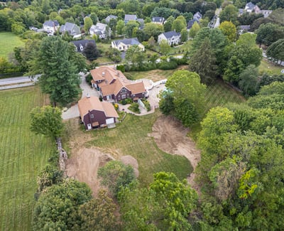 Spacious property with a large backyard, pool, and surrounding greenery, perfect for recreation and relaxation.