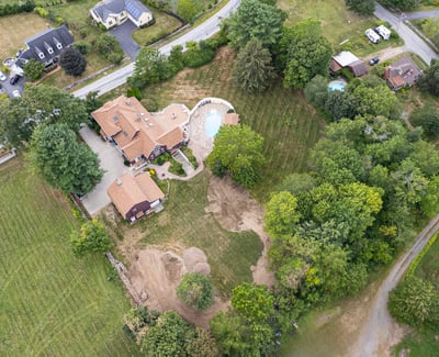 Stunning property featuring a spacious home, inviting pool, and expansive landscaped grounds in a peaceful setting.