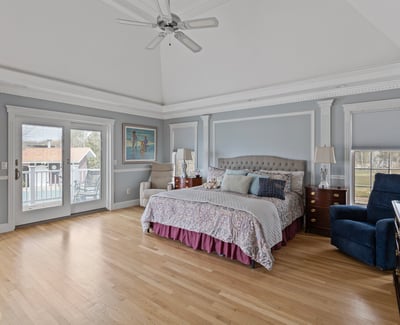 Spacious master bedroom with vaulted ceiling, private balcony access, and ample natural light. Perfect for relaxation.