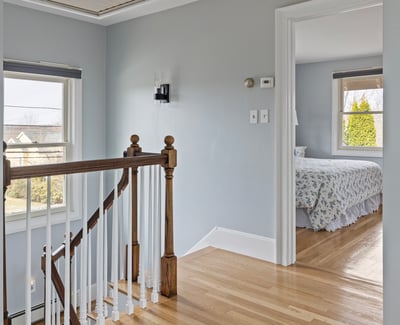 Bright and inviting, this well-lit landing leads to a cozy bedroom with lovely views.