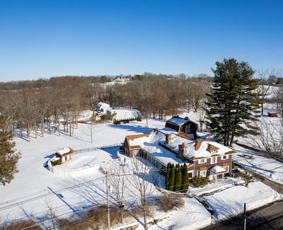 Spacious country property with expansive snow-covered grounds and classic architecture, perfect for year-round living.